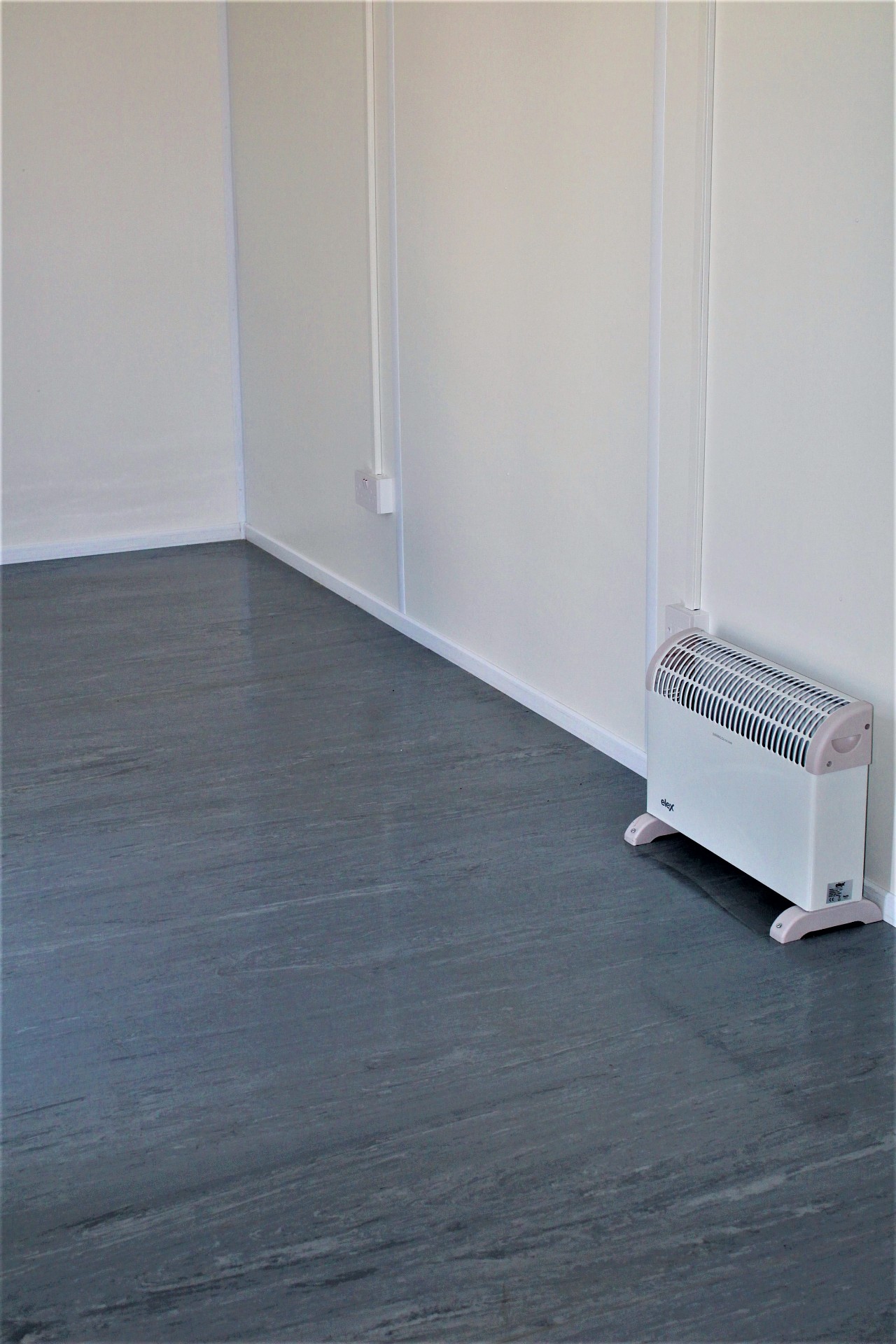 Close-up of office flooring and electric heater