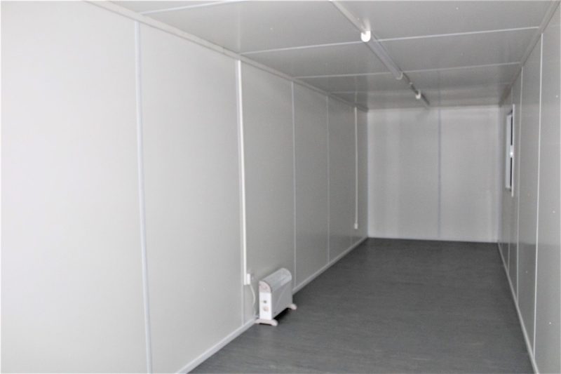 Interior view of a finished mobile office with vinyl flooring